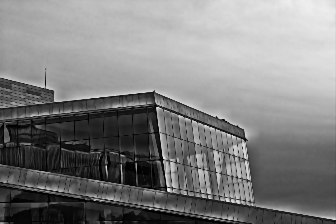 A black and white photo of the Oslo Opera House with a painterly edit